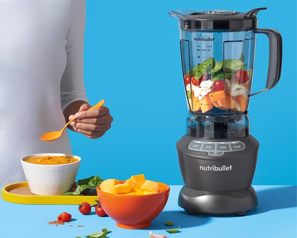 Πρόσωπο που συγκρατεί αναμεμειγμένο smoothie με μπλέντερ Nutribullet