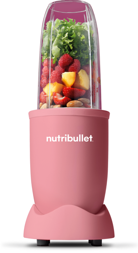 Matte pink nutribullet® pro blender filled with strawberries, kale, mango, raspberries and almonds